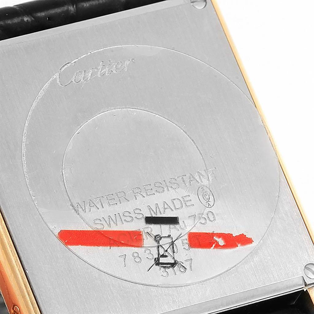 The image shows the back case of a Cartier Tank Solo W1018855 Men
s Steel and Gold (two tone) Silver Dial W1018855 Men
s Steel and Gold (two tone) Silver Dial watch, highlighting its engraved details and markings.