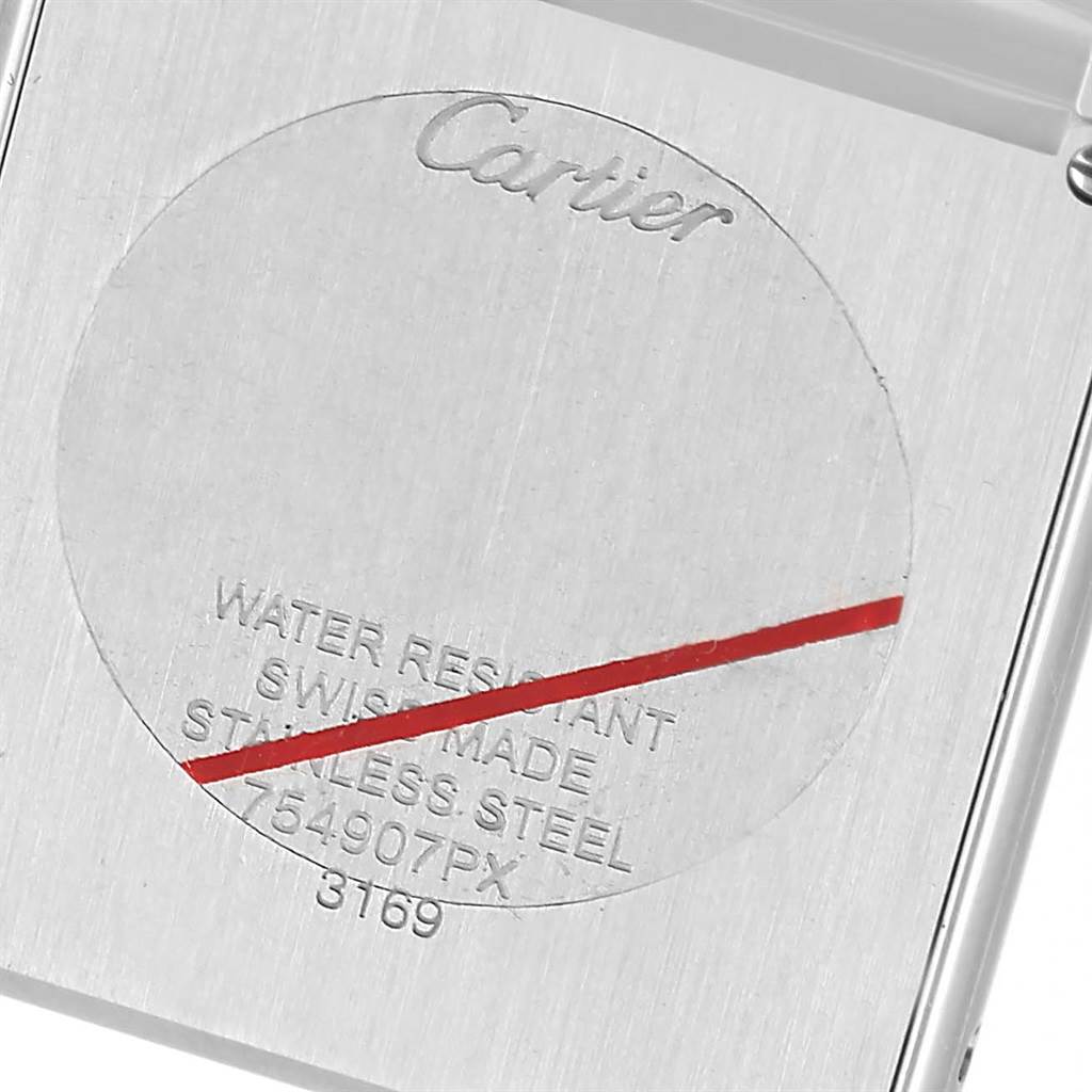 The image shows a close-up of the back case of a Cartier Tank Solo W5200014 Men
s Stainless Steel Silver Dial W5200014 Men
s Stainless Steel Silver Dial watch, highlighting its etched markings and branding.