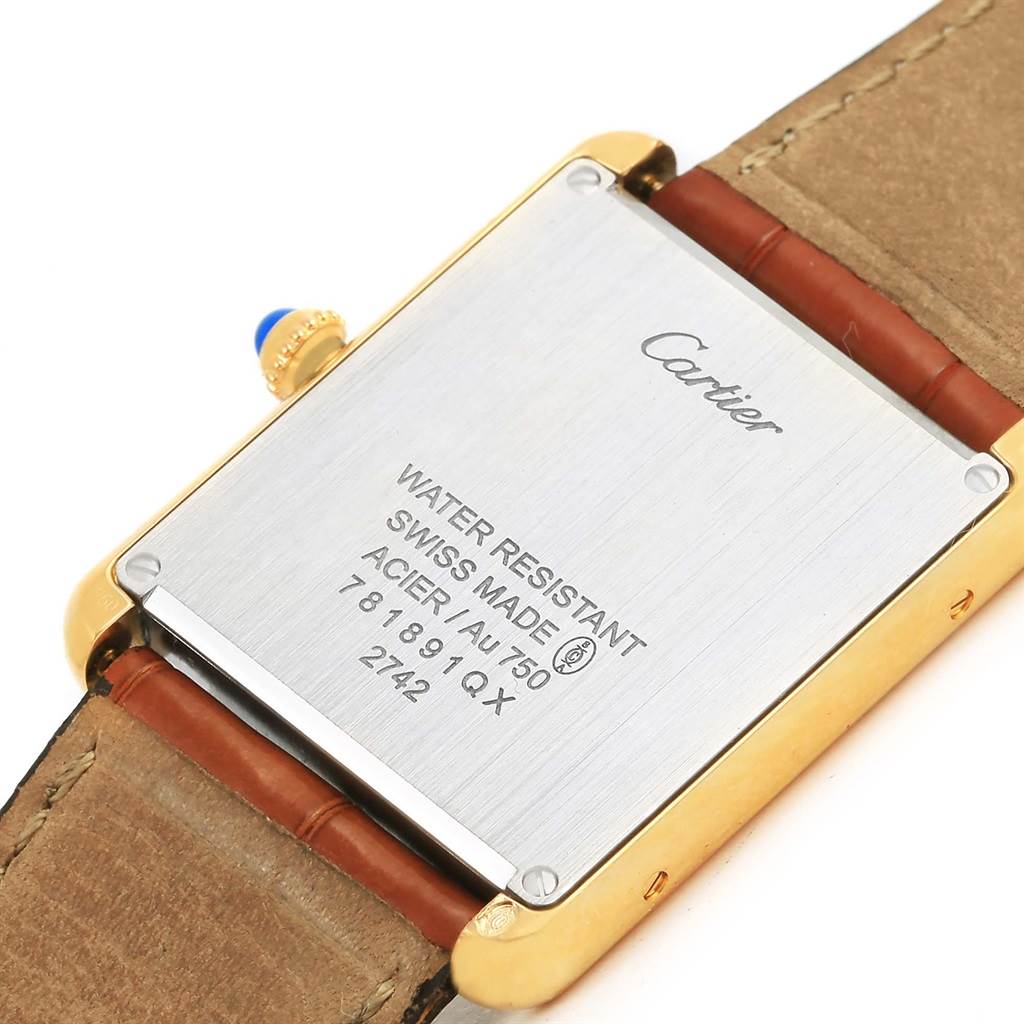 This image shows the back case of a Cartier Tank Solo W1018855 Men
s Steel and Gold (two tone) Silver Dial W1018855 Men
s Steel and Gold (two tone) Silver Dial watch, emphasizing its inscriptions and leather strap attachment.