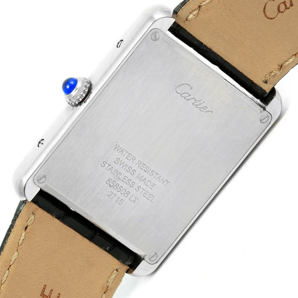 The image shows the back casing of a Cartier Tank Solo W1018355 Men
s Stainless Steel Silver Dial W1018355 Men
s Stainless Steel Silver Dial watch, detailing its water resistance, Swiss-made stainless steel, and serial numbers.