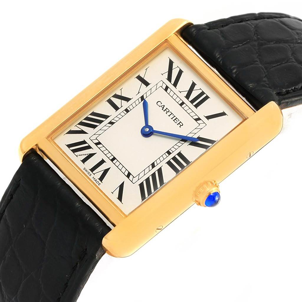 The image shows a Cartier Tank Solo W1018855 Steel and Gold (two tone) Silver Dial W1018855 Steel and Gold (two tone) Silver Dial watch with a gold case, black leather strap, and blue hands on a white dial with Roman numeral markers.