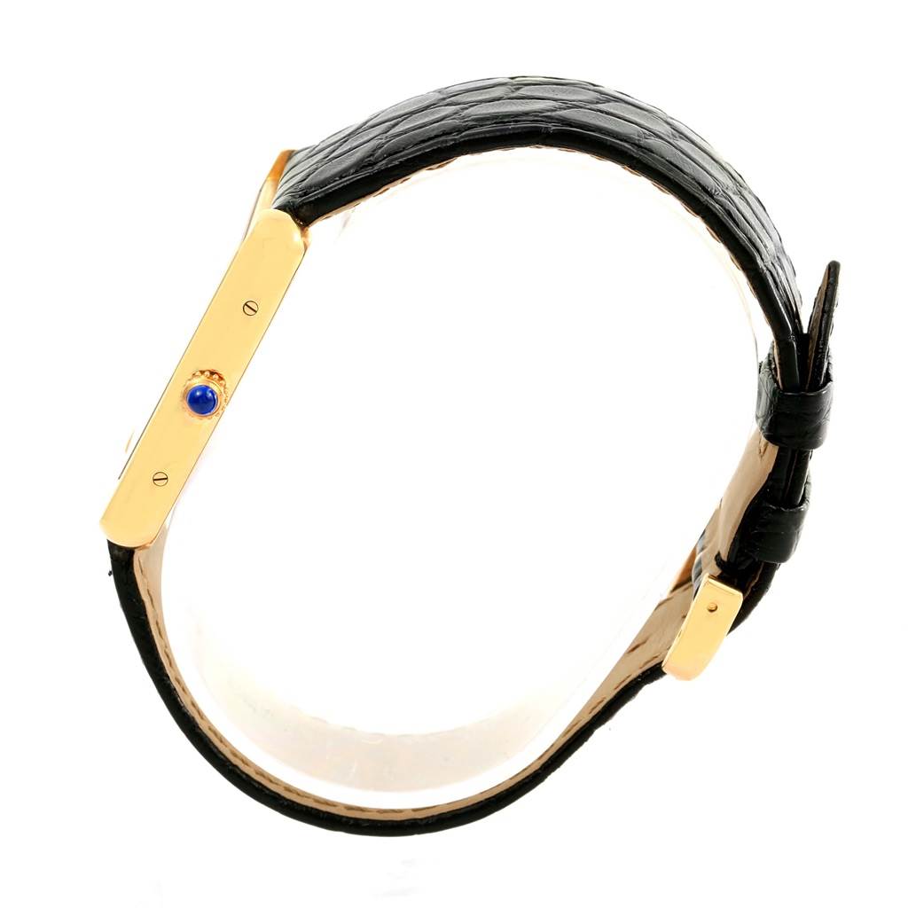 The image shows a side view of a Cartier Tank Solo W1018855 Steel and Gold (two tone) Silver Dial W1018855 Steel and Gold (two tone) Silver Dial watch, displaying its black leather strap and gold case with a blue cabochon crown.