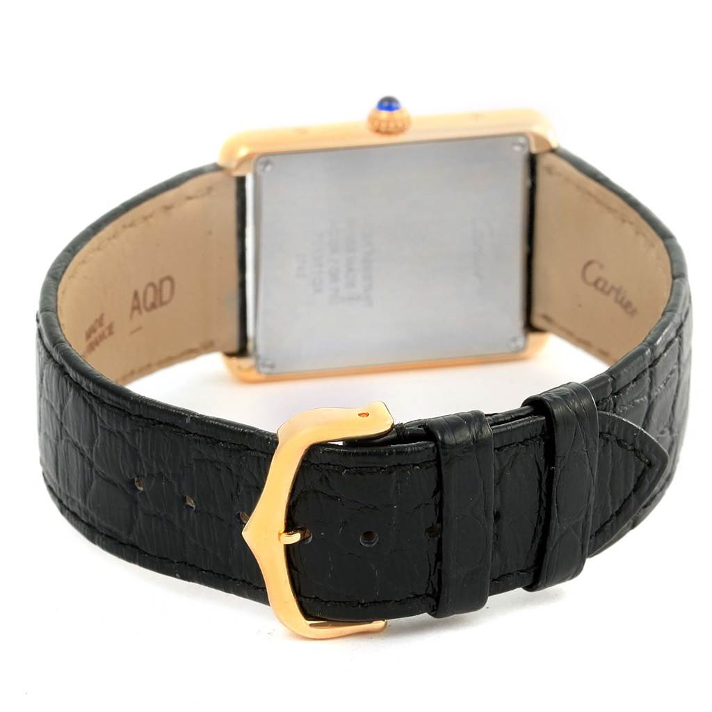 The image shows the back view of a Cartier Tank Solo W1018855 Steel and Gold (two tone) Silver Dial W1018855 Steel and Gold (two tone) Silver Dial watch, highlighting the leather strap and gold buckle.