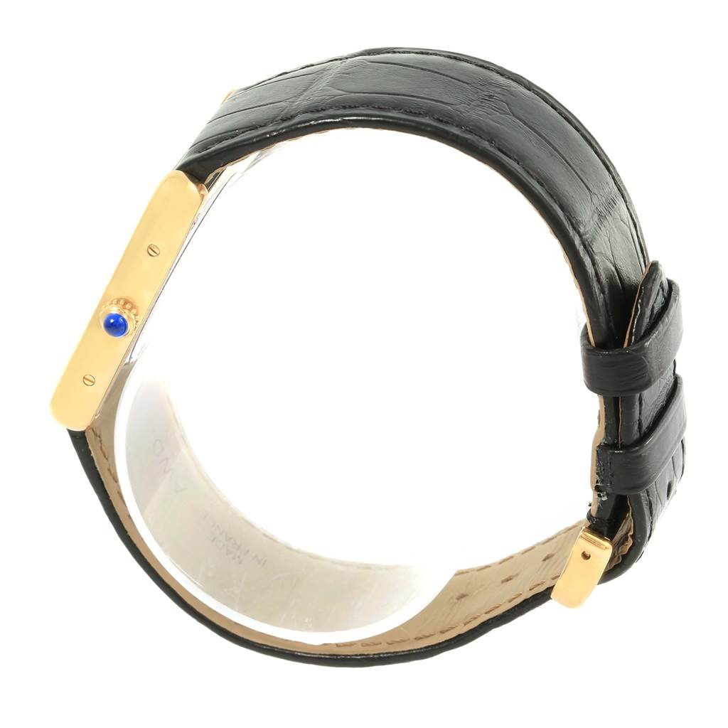 The image shows a Tank Solo watch by Cartier viewed from the side, highlighting the crown and black leather strap.