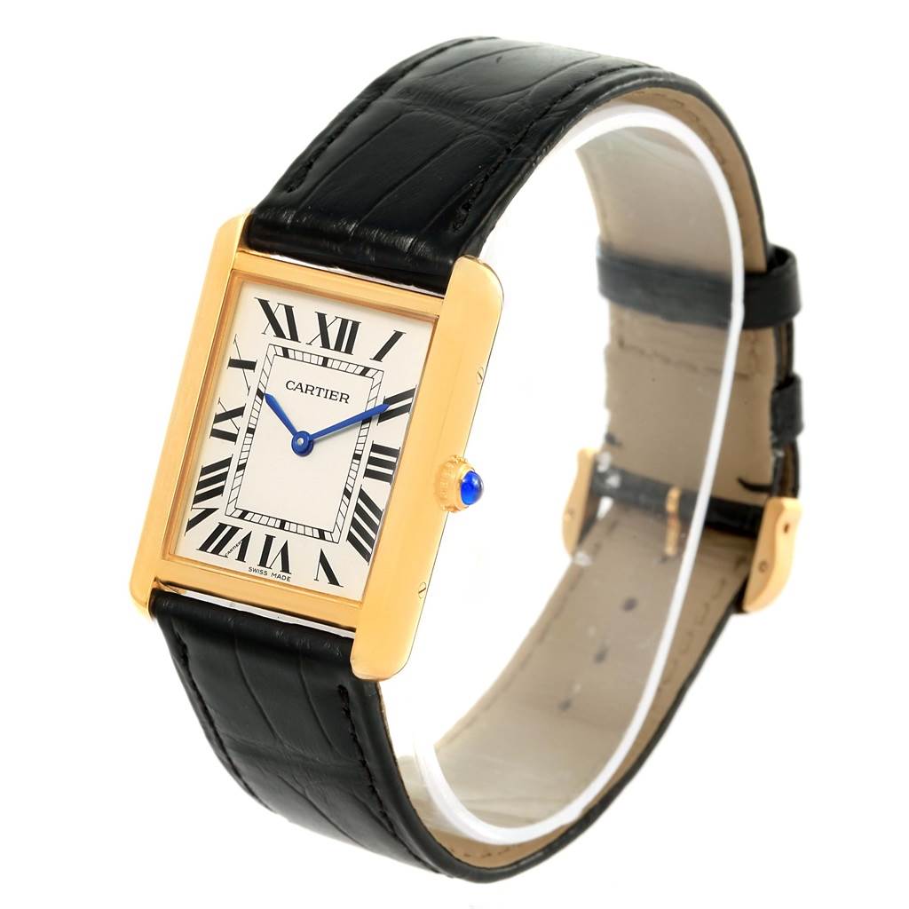 The Cartier Tank Solo W1018855 Steel and Gold (two tone) Silver Dial W1018855 Steel and Gold (two tone) Silver Dial watch is shown at an angled side view, displaying its face, black leather strap, and gold case with a blue cabochon crown.