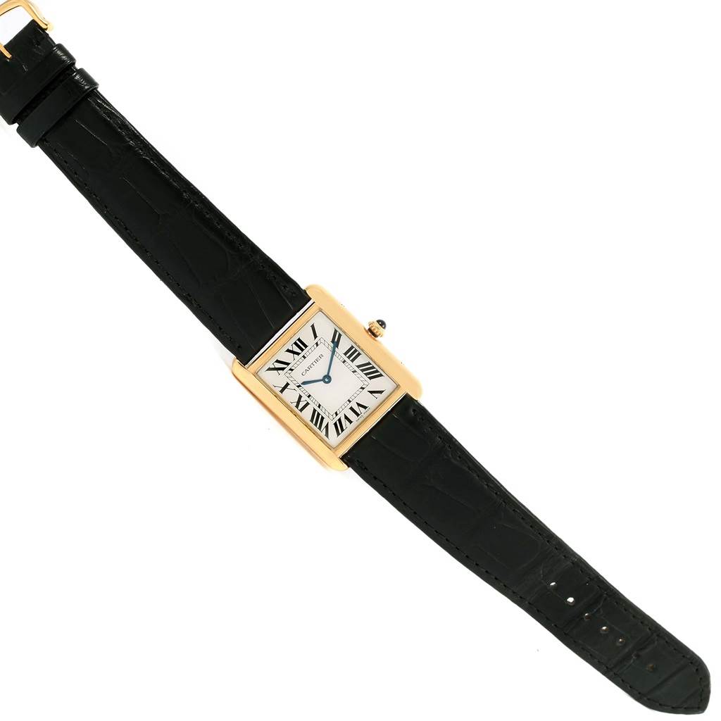 The Cartier Tank Solo W1018855 Steel and Gold (two tone) Silver Dial W1018855 Steel and Gold (two tone) Silver Dial watch is shown at an angled view, displaying its rectangular face, Roman numerals, and black leather strap.