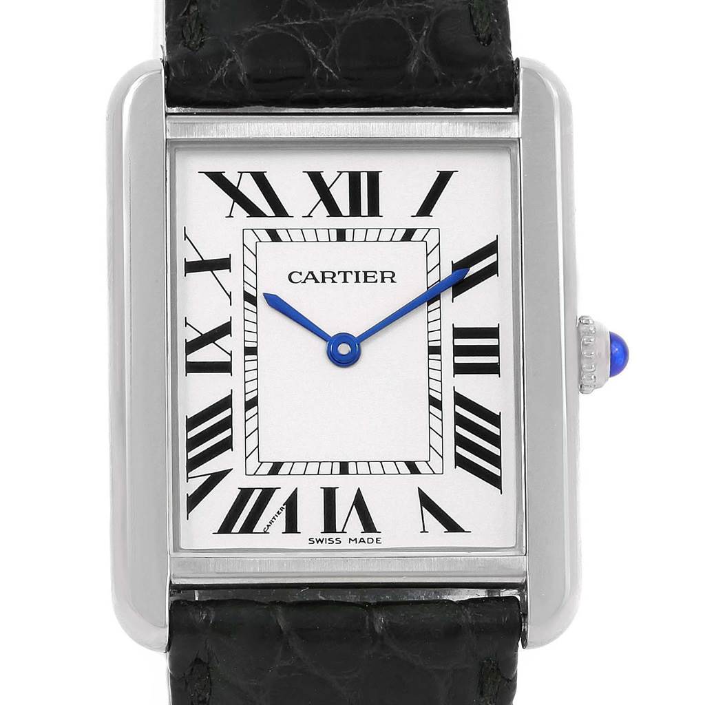 The image shows a front view of the Cartier Tank Solo W1018355 Men
s Stainless Steel Silver Dial W1018355 Men
s Stainless Steel Silver Dial watch face with a leather strap and a blue cabochon crown.
