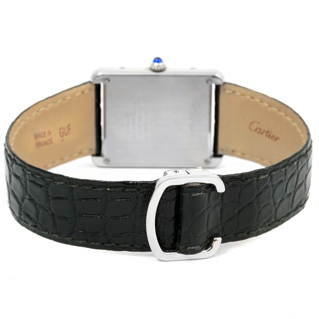 The image shows the back view of a Cartier Tank Solo W1018355 Men
s Stainless Steel Silver Dial W1018355 Men
s Stainless Steel Silver Dial watch featuring its case, leather strap, and clasp.