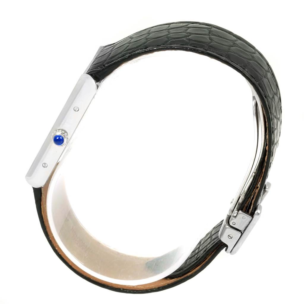 The image shows a side angle of the Cartier Tank Solo W1018355 Stainless Steel Silver Dial W1018355 Stainless Steel Silver Dial watch, highlighting the crown, bezel, and leather strap with a clasp.