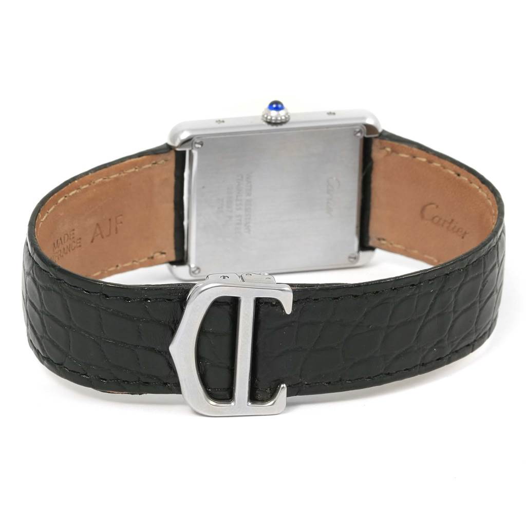 The image shows the back of the Cartier Tank Solo W1018355 Stainless Steel Silver Dial W1018355 Stainless Steel Silver Dial watch and its black leather strap with a 
Cartier
 buckle.