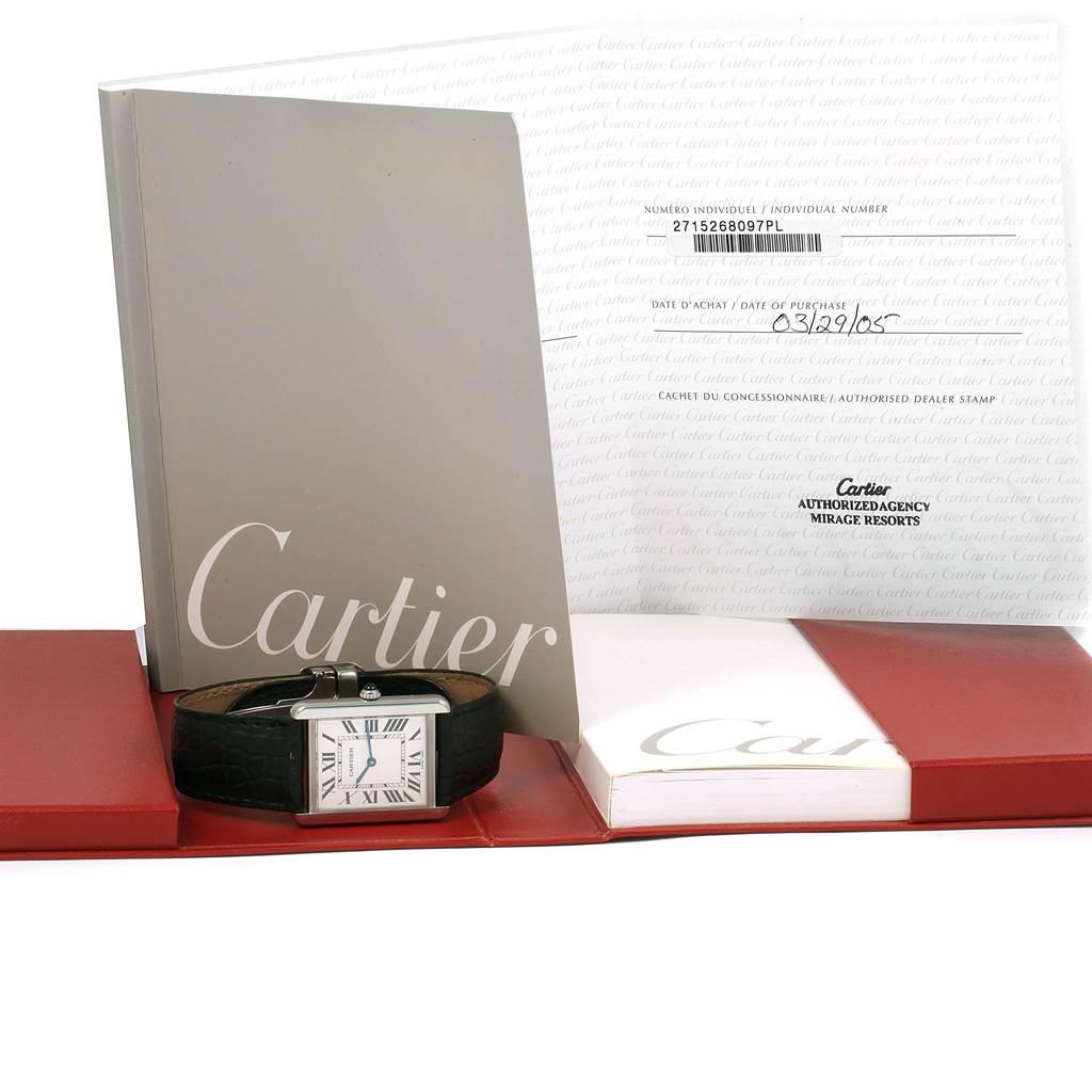 The image contains a Cartier Tank Solo W1018355 Stainless Steel Silver Dial W1018355 Stainless Steel Silver Dial watch laid flat, accompanied by its booklet and documents.