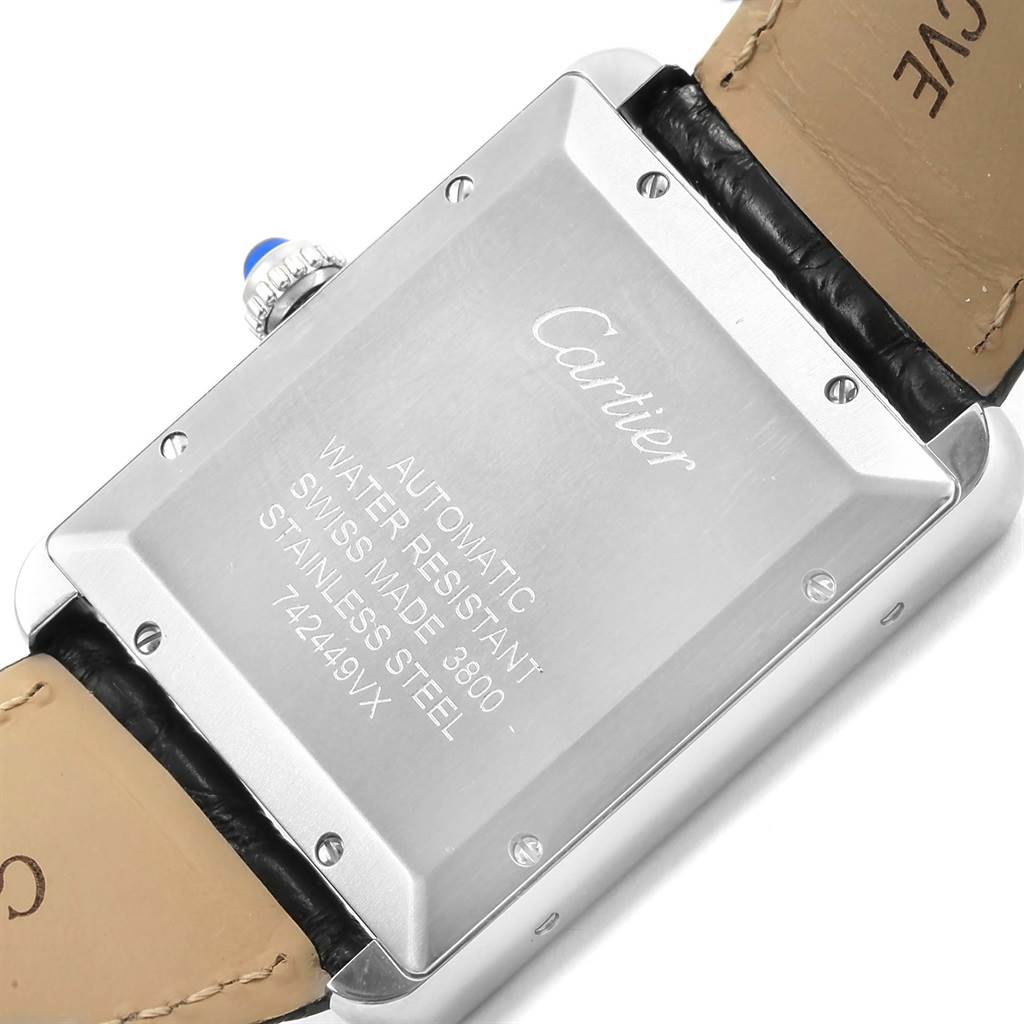 The image shows the back of a Cartier Tank Solo W5200027 Men
s Stainless Steel Silver Dial W5200027 Men
s Stainless Steel Silver Dial watch with engraved details and part of the leather strap.