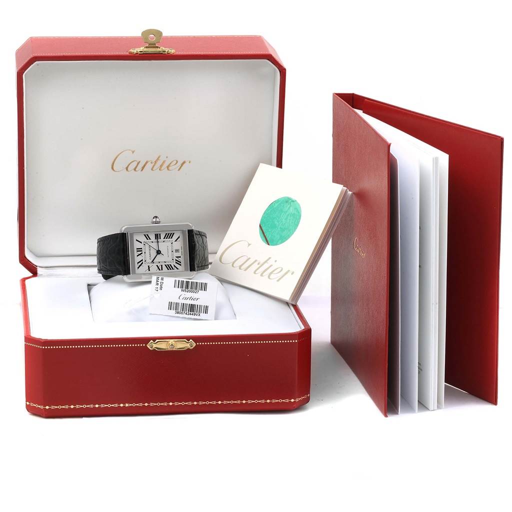The image shows a Cartier Tank Solo W5200027 Men
s Stainless Steel Silver Dial W5200027 Men
s Stainless Steel Silver Dial watch in its box, along with the warranty card and user manuals.