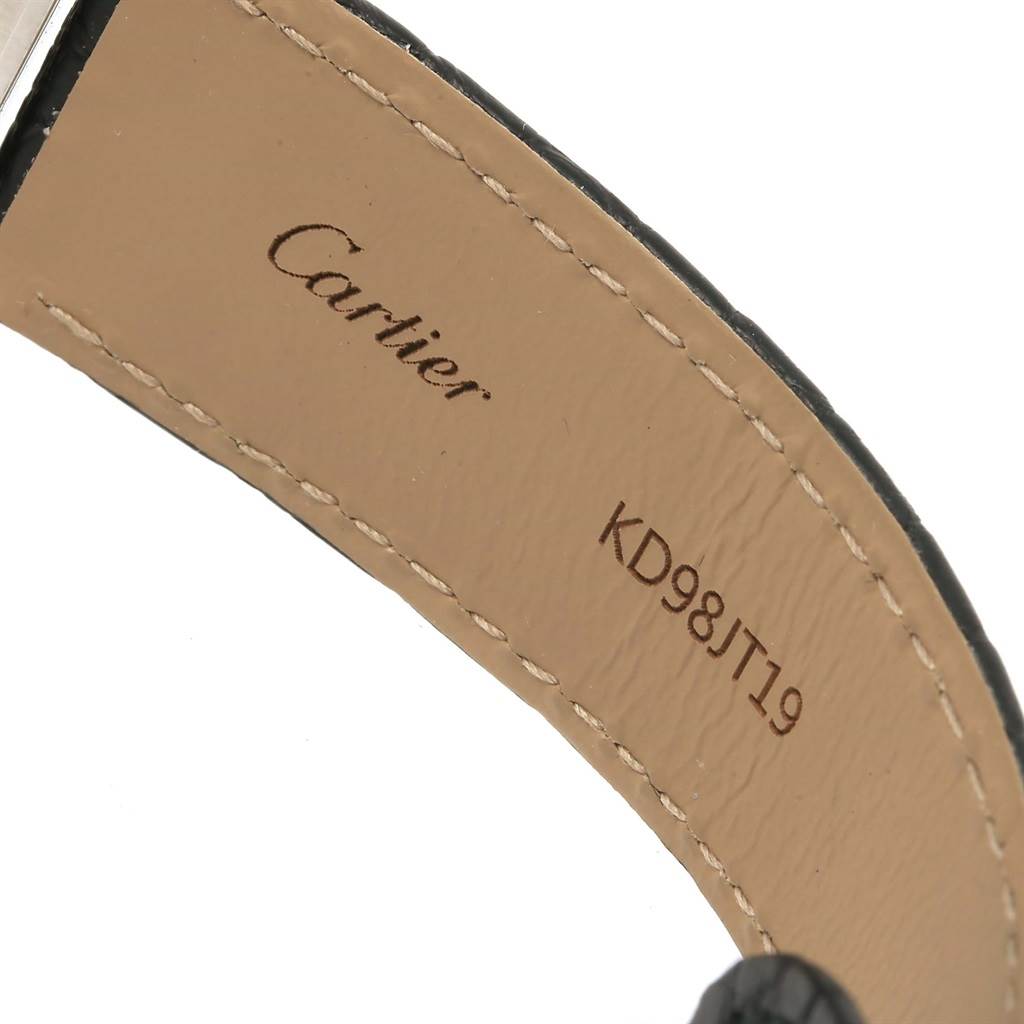 The image shows a close-up of the inner side of the leather strap of a Cartier Tank Solo W1018355 Stainless Steel Silver Dial W1018355 Stainless Steel Silver Dial watch, featuring the Cartier logo and serial number.