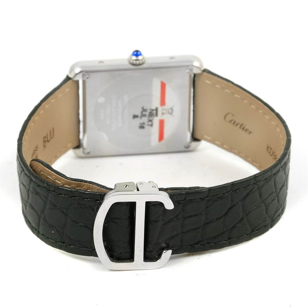 The image shows the backside of a Cartier Tank Solo W1018355 Stainless Steel Silver Dial W1018355 Stainless Steel Silver Dial watch with a visible leather strap and buckle.