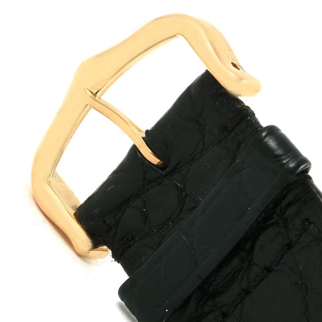 This image shows a close-up of the gold buckle and part of the black leather strap for the Cartier Tank Solo W1018855 Steel and Gold (two tone) Silver Dial W1018855 Steel and Gold (two tone) Silver Dial watch.