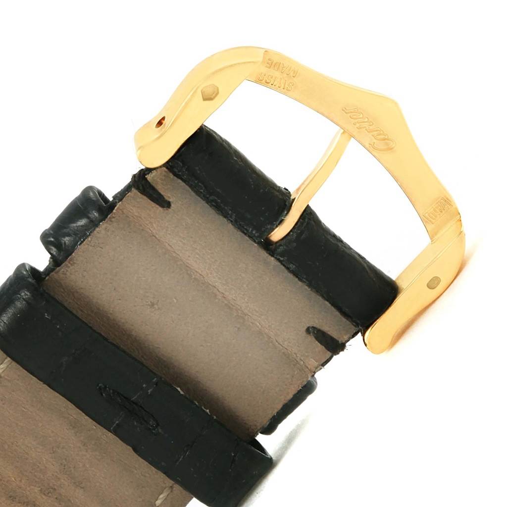 This image shows a close-up of the gold buckle and leather strap of a Cartier Tank Solo W1018855 Steel and Gold (two tone) Silver Dial W1018855 Steel and Gold (two tone) Silver Dial watch.