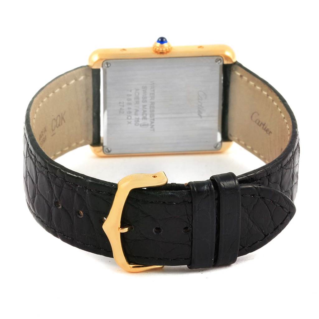 The image shows the back view of a Cartier Tank Solo W1018855 Steel and Gold (two tone) Silver Dial W1018855 Steel and Gold (two tone) Silver Dial watch, highlighting its clasp and leather strap.