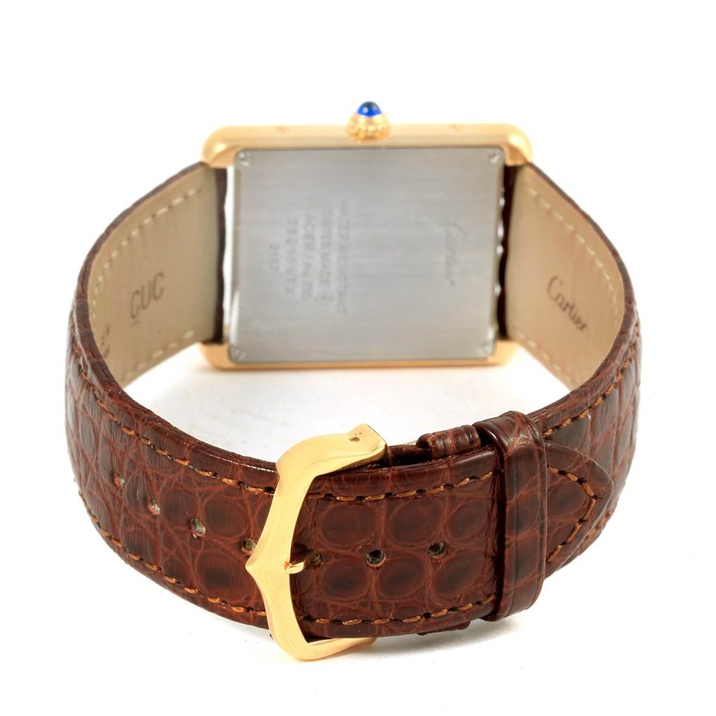 This image shows the rear view of the Cartier Tank Solo W1018855 Steel and Gold (two tone) Silver Dial W1018855 Steel and Gold (two tone) Silver Dial watch, highlighting its gold case, leather strap, and buckle.