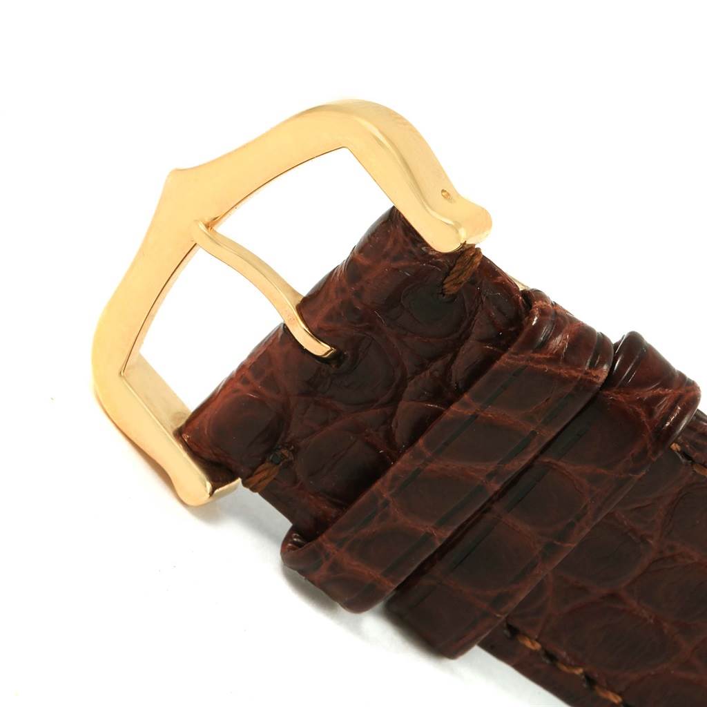 This image features a close-up view of the brown leather strap and gold buckle of a Cartier Tank Solo W1018855 Steel and Gold (two tone) Silver Dial W1018855 Steel and Gold (two tone) Silver Dial watch.