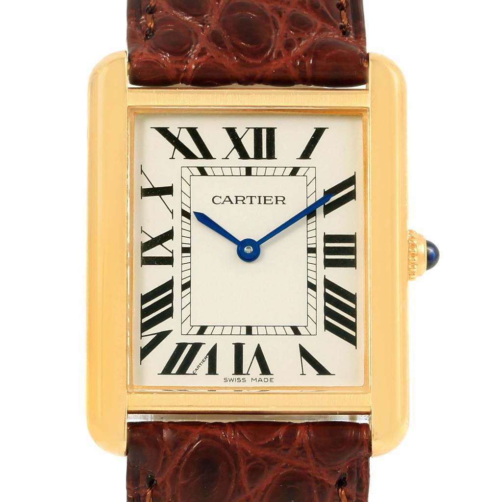This image shows a frontal view of a Tank Solo model by Cartier, featuring its dial, blue hands, Roman numerals, and brown strap.