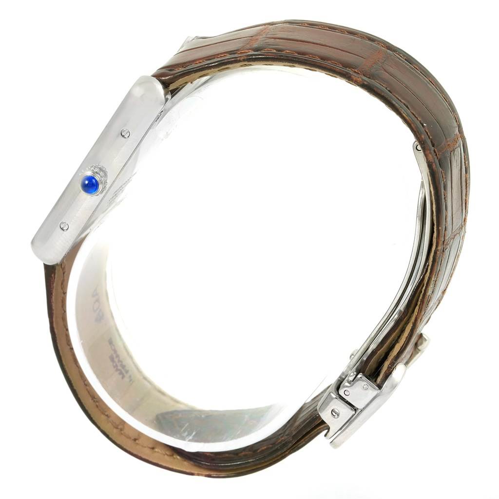 The image shows the side view of a Cartier Tank Solo W1018355 Stainless Steel Silver Dial W1018355 Stainless Steel Silver Dial watch, highlighting its crown with a blue cabochon and leather strap.