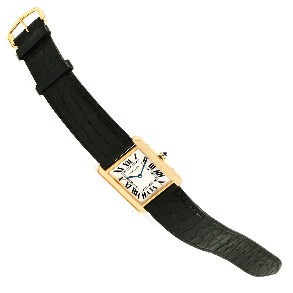 The Tank Solo watch by Cartier is shown from an angled top view, highlighting its black strap and rectangular face.