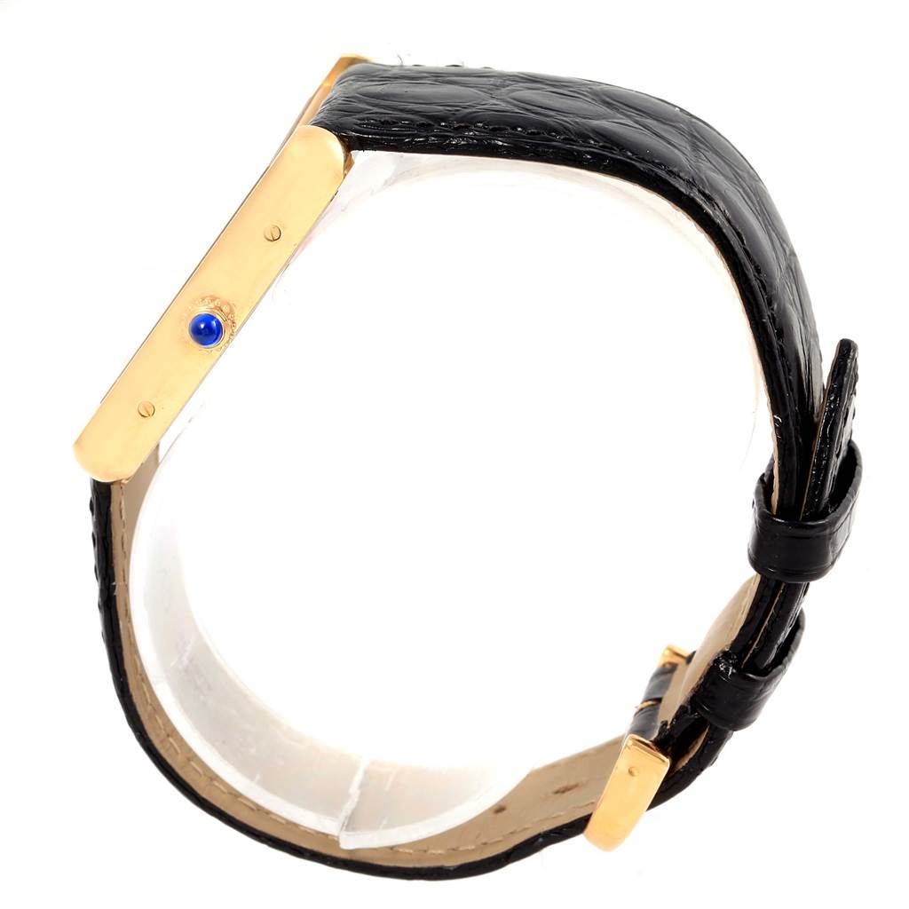 This image shows a side angle of a Cartier Tank Solo W1018855 Steel and Gold (two tone) Silver Dial W1018855 Steel and Gold (two tone) Silver Dial watch, focusing on the case, band, and crown with a blue gem.