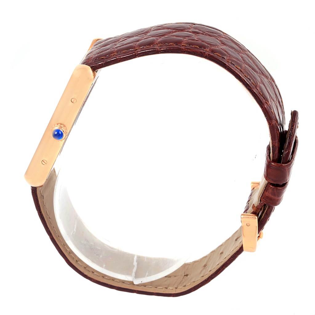 The image shows the side and partial top view of a Cartier Tank Solo W5200025 Steel and Gold (two tone) Silver Dial W5200025 Steel and Gold (two tone) Silver Dial watch, highlighting the watch band and the crown with a blue gemstone.