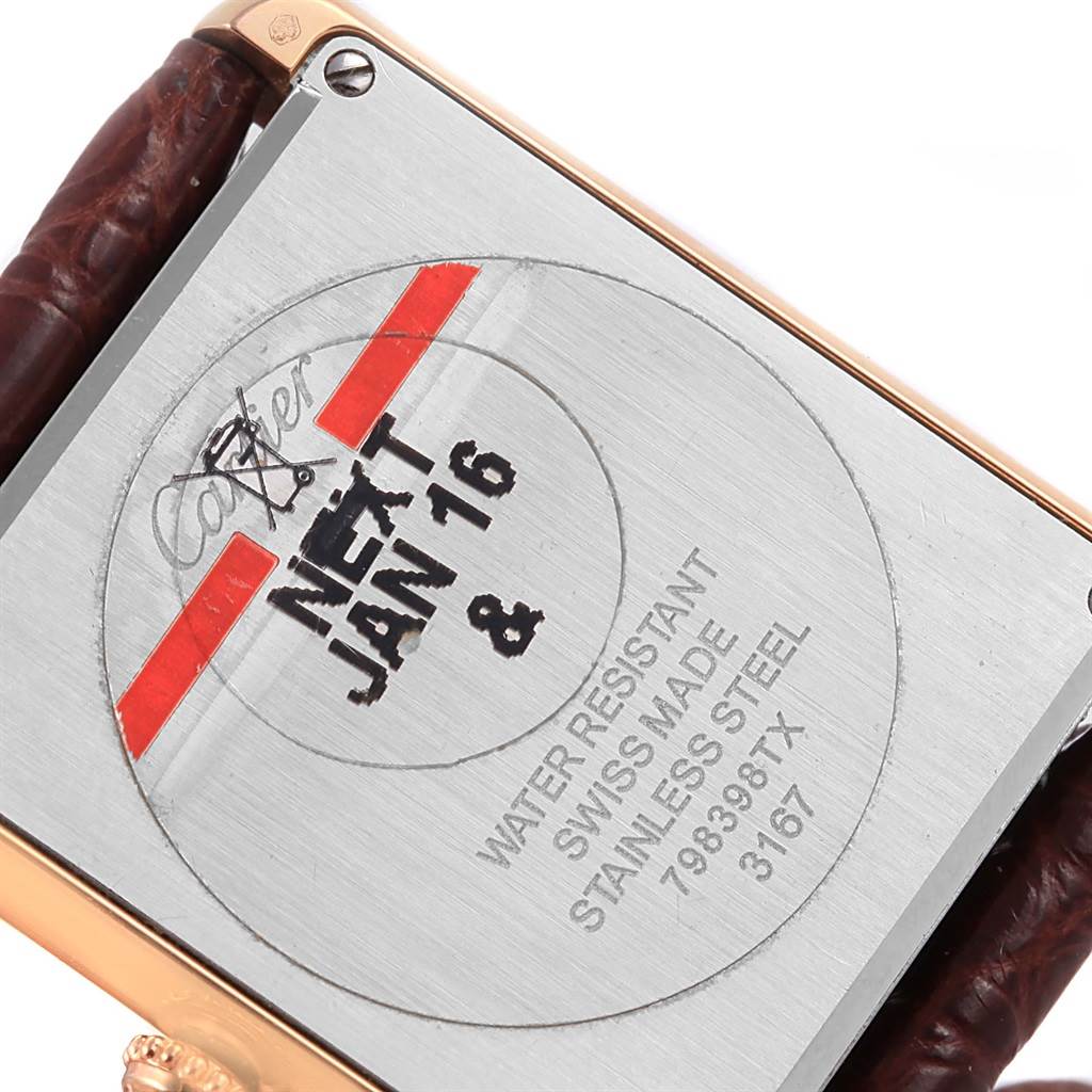 This image shows the back casing of a Cartier Tank Solo W5200025 Steel and Gold (two tone) Silver Dial W5200025 Steel and Gold (two tone) Silver Dial watch, highlighting its inscriptions and a portion of the leather strap.