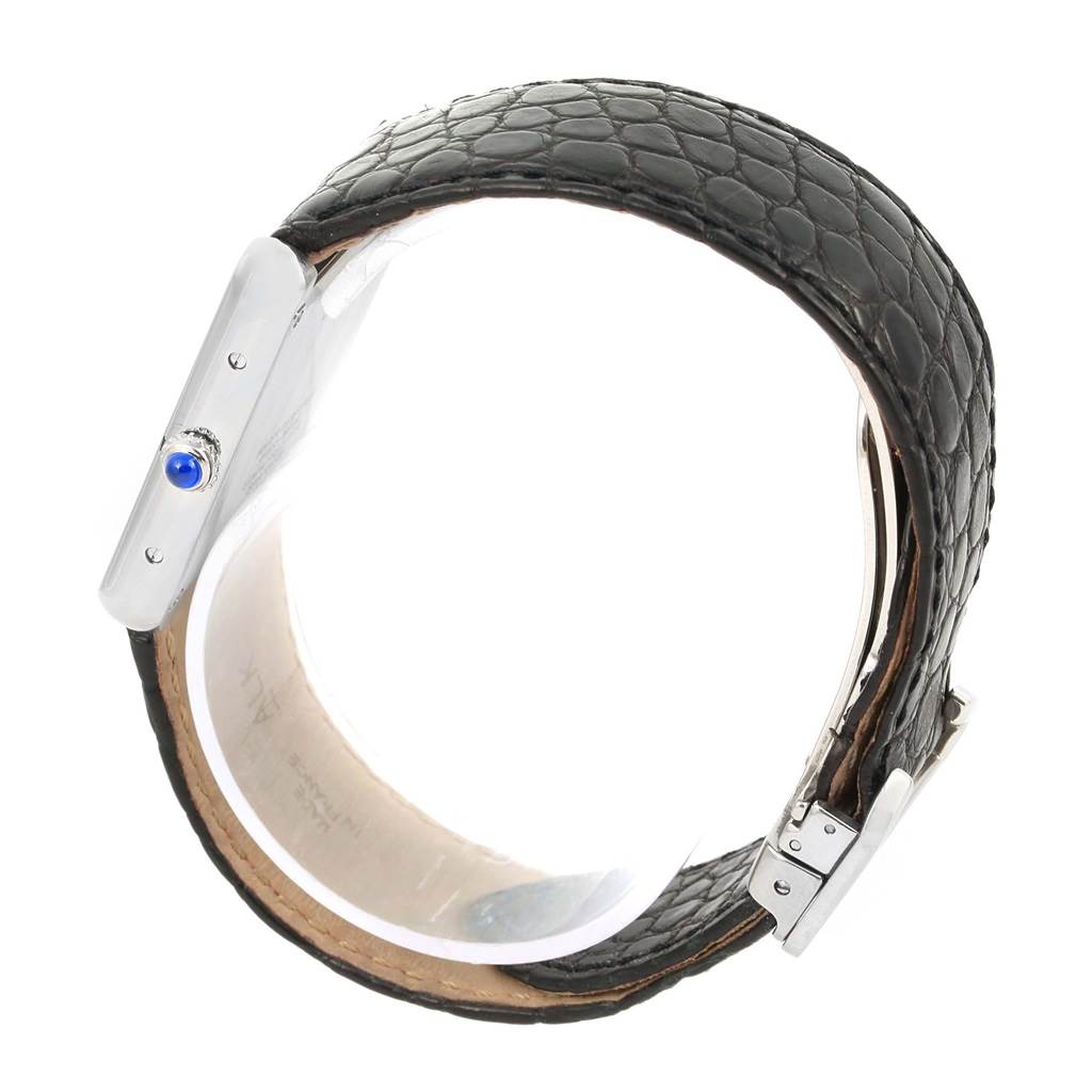 The Cartier Tank Solo W1018355 Stainless Steel Silver Dial W1018355 Stainless Steel Silver Dial watch is shown from a side angle, highlighting the crown with a blue cabochon and its black leather strap.