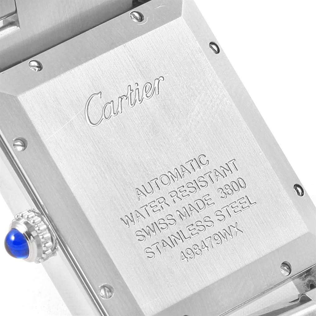 The image shows the back case and crown of a Tank Solo model by Cartier, with engraved details on the back.