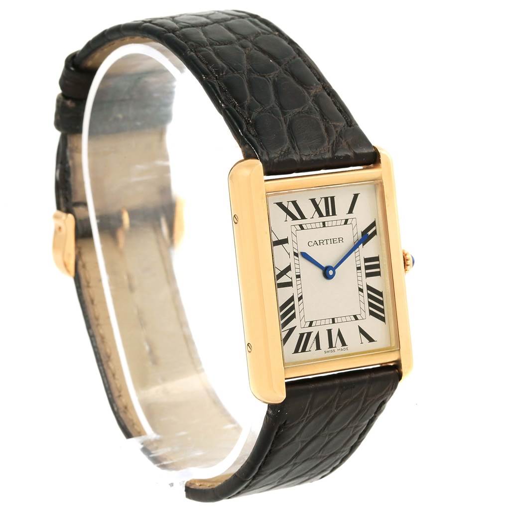 The Cartier Tank Solo W1018855 Steel and Gold (two tone) Silver Dial W1018855 Steel and Gold (two tone) Silver Dial watch is shown at an oblique angle, highlighting its rectangular case, black leather strap, and Roman numeral dial.