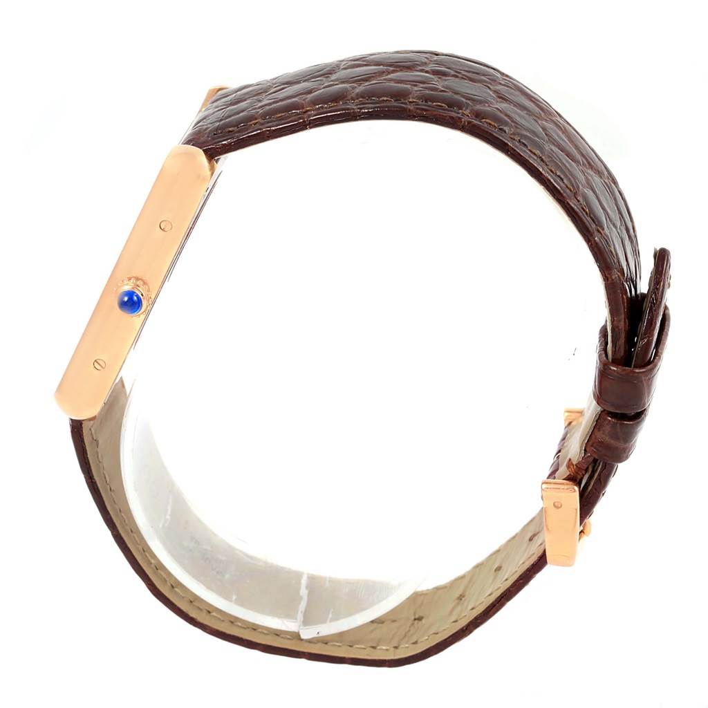 The image shows a side view of a Cartier Tank Solo W5200025 Steel and Gold (two tone) Silver Dial W5200025 Steel and Gold (two tone) Silver Dial watch with a brown leather strap and a visible blue cabochon crown.