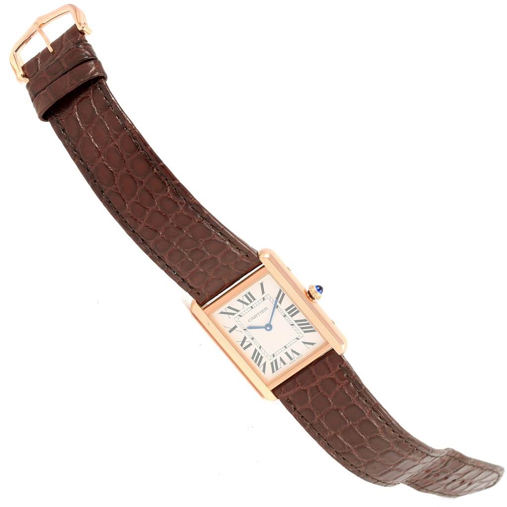 The image displays a Tank Solo model by Cartier, showing a top view of the watch with a brown leather strap and rectangular dial.