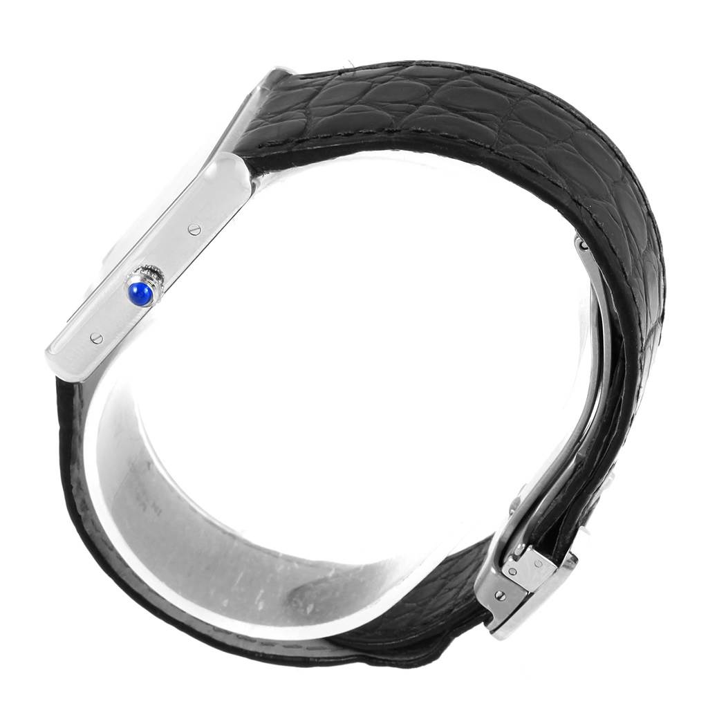 This image shows a Cartier Tank Solo W1018355 Stainless Steel Silver Dial W1018355 Stainless Steel Silver Dial watch viewed from the side, highlighting its black leather strap and crown with a blue cabochon.