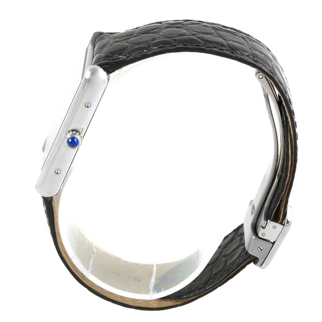 The image shows the side view of a Cartier Tank Solo W1018355 Stainless Steel Silver Dial W1018355 Stainless Steel Silver Dial watch, highlighting its black leather strap and the blue cabochon on the crown.