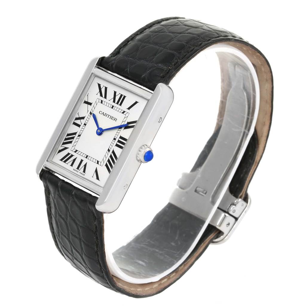 The Cartier Tank Solo W1018355 Stainless Steel Silver Dial W1018355 Stainless Steel Silver Dial watch is shown at a slight angle, highlighting its rectangular face, Roman numerals, blue hands, crown, and leather strap.