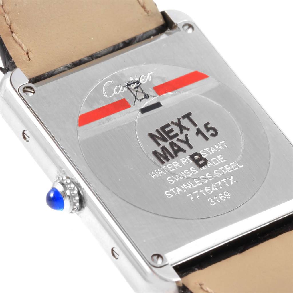 The image shows the back view of a Cartier Tank Solo W1018355 Stainless Steel Silver Dial W1018355 Stainless Steel Silver Dial watch, displaying its serial number, water resistance, and the crown with a blue gem.