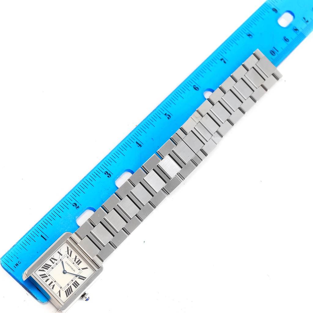 The image shows a Cartier Tank Solo W5200014 Stainless Steel Silver Dial W5200014 Stainless Steel Silver Dial watch laid flat, next to a ruler for scale, displaying the face and entire metal bracelet.