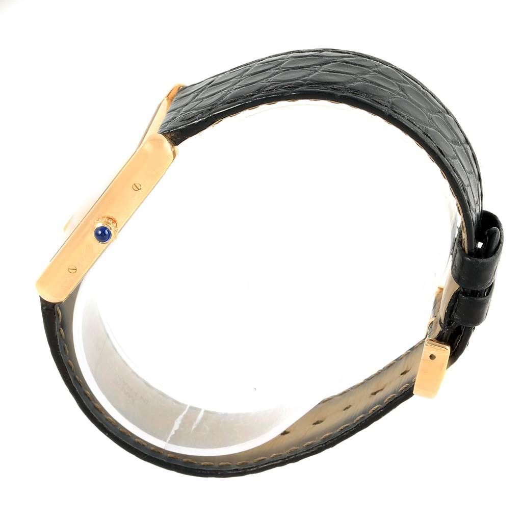 This image shows the side view of the Cartier Tank Solo W1018855 Steel and Gold (two tone) Silver Dial W1018855 Steel and Gold (two tone) Silver Dial watch, highlighting its black leather strap and gold casing.