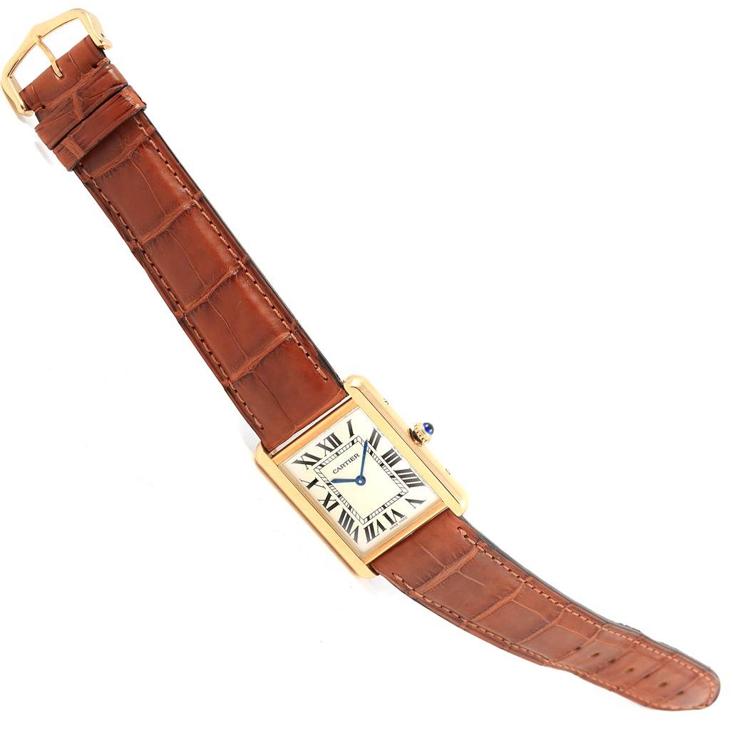 The Tank Solo watch by Cartier is shown at an angle displaying the face, crown, bezel, and brown leather strap.