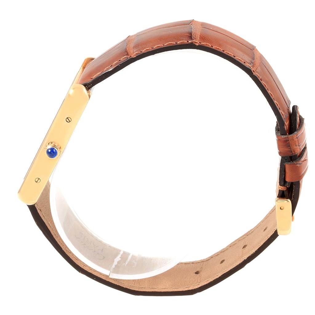 The image shows a side view of a Cartier Tank Solo W1018855 Steel and Gold (two tone) Silver Dial W1018855 Steel and Gold (two tone) Silver Dial watch, highlighting its gold case, crown, and brown leather strap.