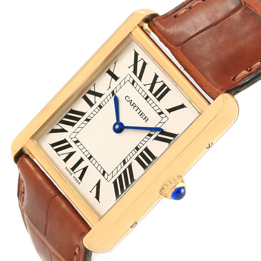 This image shows a close-up of the Cartier Tank Solo W1018855 Steel and Gold (two tone) Silver Dial W1018855 Steel and Gold (two tone) Silver Dial watch, highlighting the face, Roman numerals, blue hands, and brown leather strap.