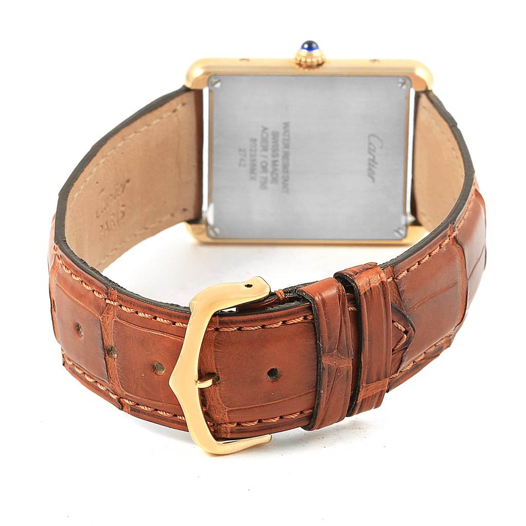 The image shows the back view of a Cartier Tank Solo W1018855 Steel and Gold (two tone) Silver Dial W1018855 Steel and Gold (two tone) Silver Dial watch, highlighting its brown leather strap and gold buckle.