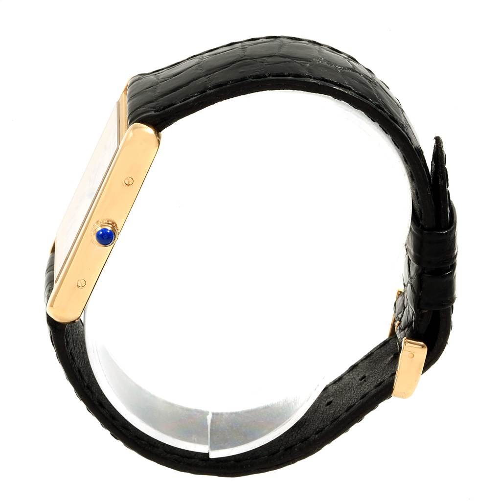 The image shows a side view of the Cartier Tank Solo W1018855 Steel and Gold (two tone) Silver Dial W1018855 Steel and Gold (two tone) Silver Dial watch, highlighting its black strap and gold case with a blue crown.