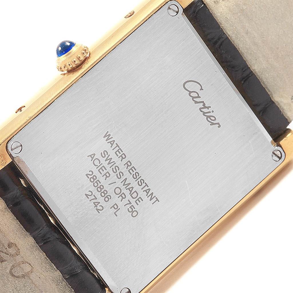 The image shows the back case and strap of a Cartier Tank Solo W1018855 Steel and Gold (two tone) Silver Dial W1018855 Steel and Gold (two tone) Silver Dial watch with details about its water resistance and materials.