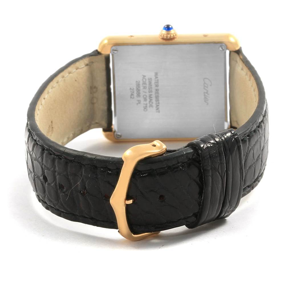 The image shows the back of a Cartier Tank Solo W1018855 Steel and Gold (two tone) Silver Dial W1018855 Steel and Gold (two tone) Silver Dial watch, highlighting its square case back and black leather strap.