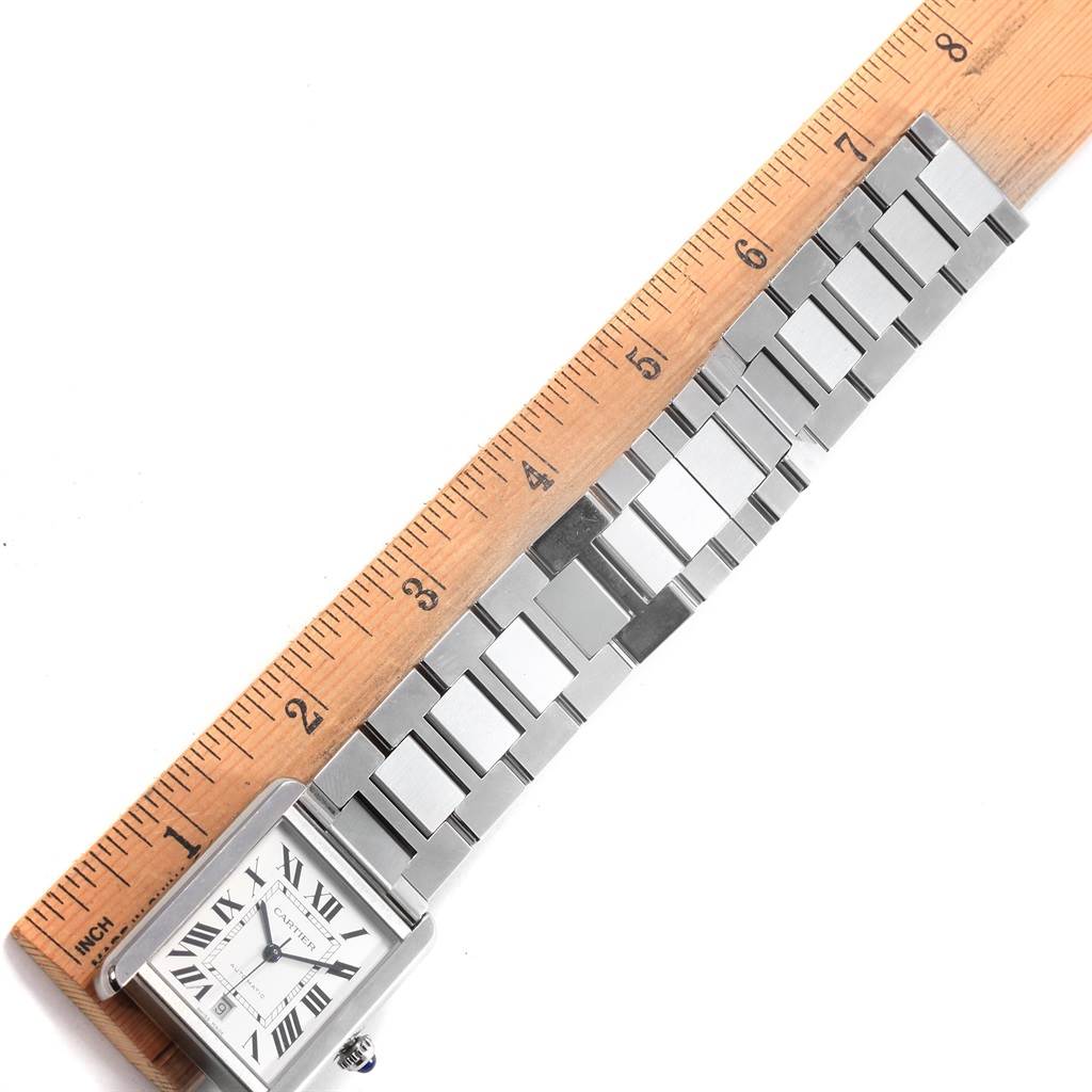 The image shows an overhead view of the Cartier Tank Solo W5200028 Men
s Stainless Steel Silver Dial W5200028 Men
s Stainless Steel Silver Dial watch, highlighting the face and metal strap against a ruler.