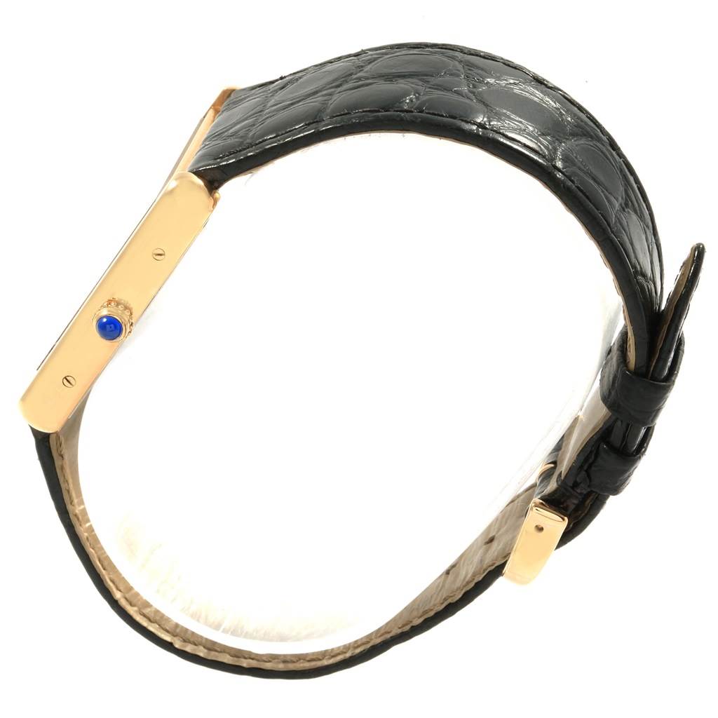 The Cartier Tank Solo W1018855 Men
s Steel and Gold (two tone) Silver Dial W1018855 Men
s Steel and Gold (two tone) Silver Dial watch is displayed from a side angle, showing the side profile, crown, and black leather strap.